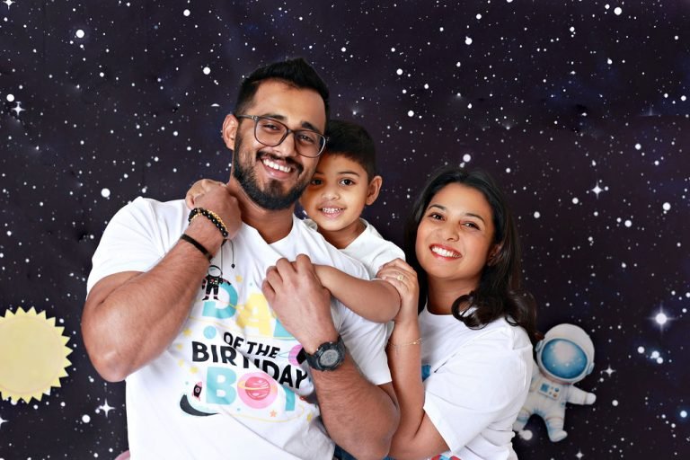 Father hugging his son at a space-themed third birthday family shoot